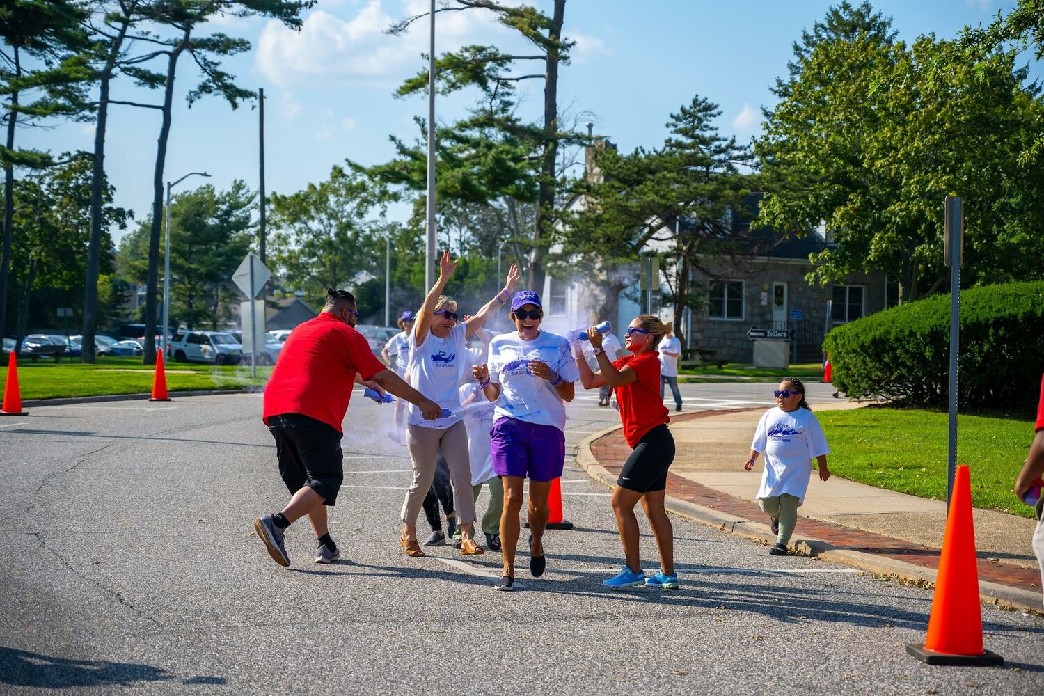 Participants of the Color Fun Run are dusted with purple powder.